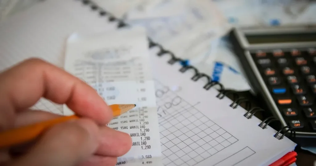 An invoice showing VAT-inclusive and VAT-exclusive amounts, next to a calculator, illustrating what VAT is